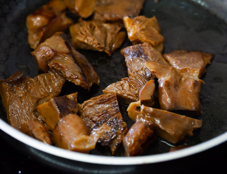 Fried mushrooms in frying pan. Roasting the chopped mushrooms in oilの写真素材