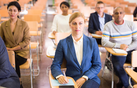 Portrait of focused female entrepreneur sitting in conference roomの写真素材