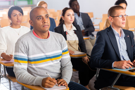 Focused man listening to lecture at conferenceの写真素材
