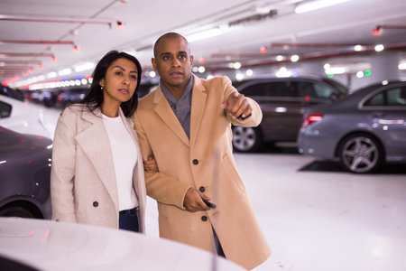 Elegant married couple in underground parking of hypermarketの写真素材