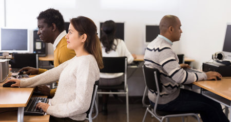 Young adult woman studying in computer classの写真素材