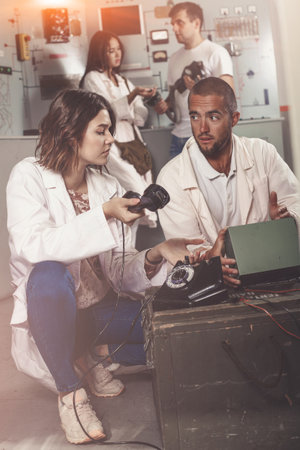 Girl and guy checking telephone set in escape roomの写真素材