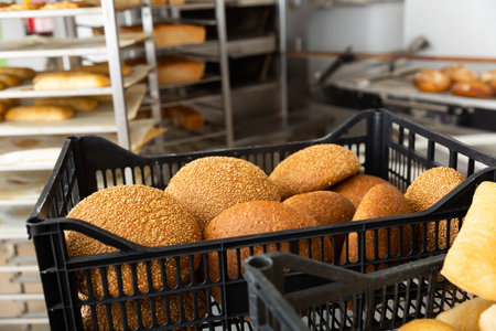 Fresh hot bread in crates in bakery