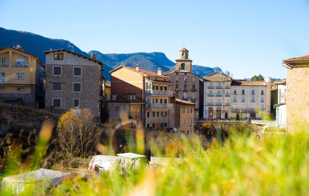 street with river and residential buildings in La Pobla de Lillet in Spainの写真素材
