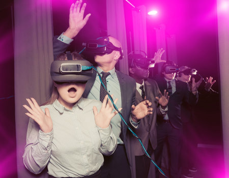 Amazed businesswoman in VR goggles. Toned image