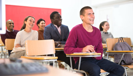 Adult students in studying with their colleagues, Focus on european man