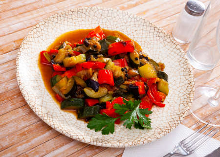 Plate of stewed vegetables on table. Vegetarian dishの写真素材
