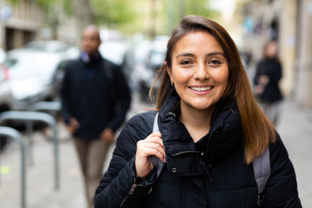 Smiling woman walking outdoors at cold dayの写真素材