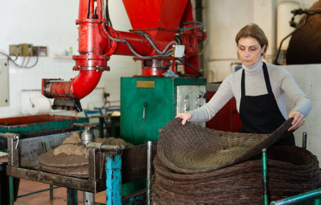 Woman applying olive paste to fiber matsの写真素材