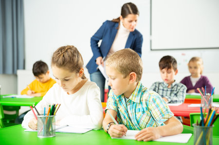 Assiduous kids studying in classroomの写真素材