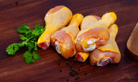 Raw chicken legs on cutting board and plate closeupの写真素材