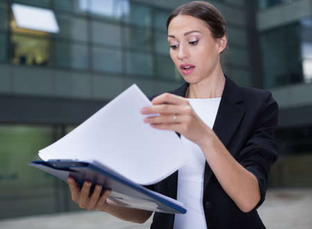 Serious woman is dissatisfied of the results of the financial reportの写真素材