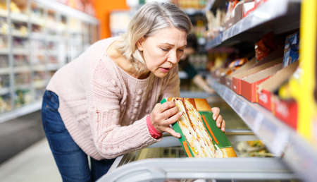 Mature woman shopping in supermarketの写真素材