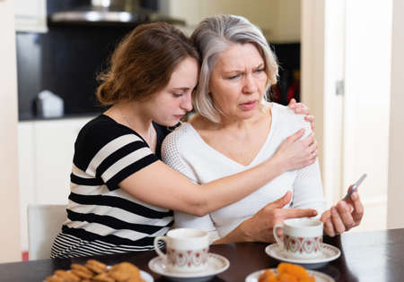 Upset women using smartphoneの写真素材