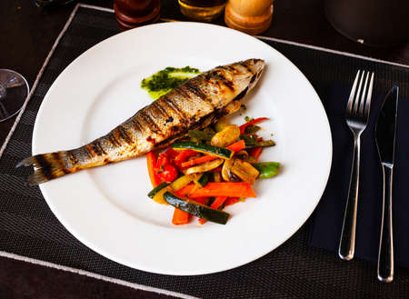 Sea bass, grilled with zucchini, pepper and mushroomsの写真素材