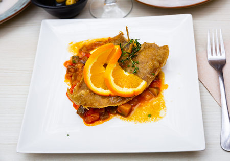 Black sole fish with stewed vegetables and orange