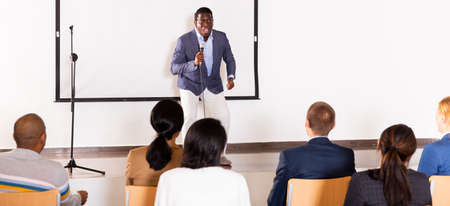 Young emotional male coach giving motivational speechの写真素材