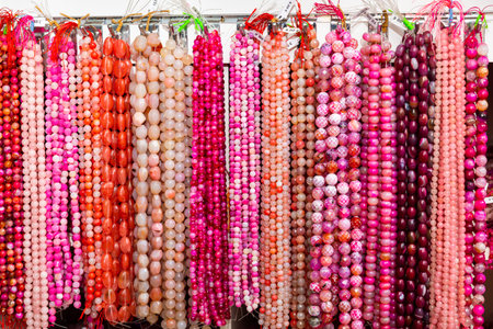 Beads from gems strung on thread in jewelry accessories store