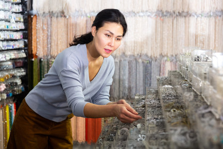 Asian woman shopping and searching adornments in boutique