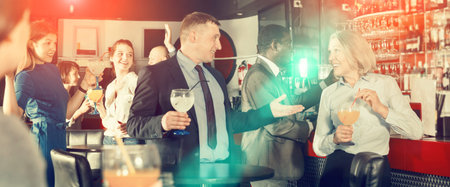 Man talking to woman on corporate party