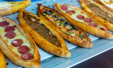 Traditional Turkish pide with various fillings on bakery showcaseの写真素材