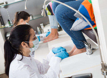 Nail pedicure technician performing procedureの写真素材