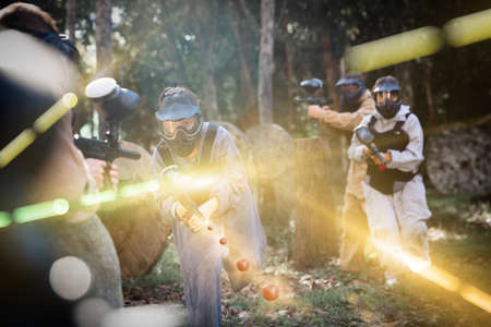 Men and women playing paintballの写真素材
