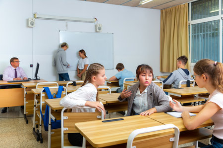 Teenage students talking during recess between lessonsの写真素材