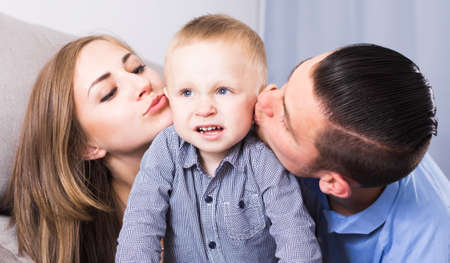 Glad wife and positive husband with little childの写真素材