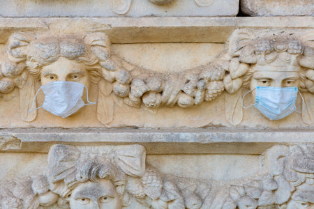 Relief sculptures with wearing medical masks in ancient city of Aphrodisias. Turkeyの写真素材