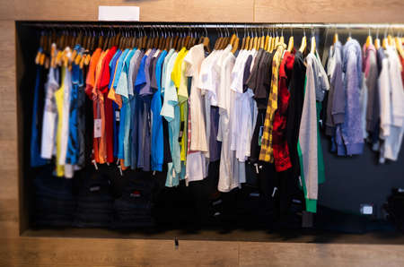 Variety of male wear on hangers and shelvesの写真素材