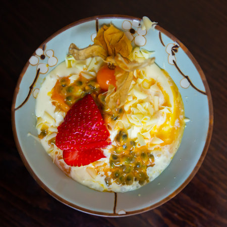 Delicate passion fruit mousse with yogurt, strawberry and physalisの写真素材