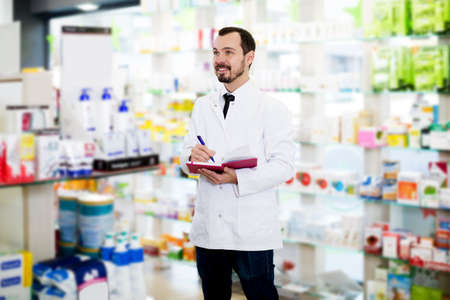 Male pharmacist checking assortment of drugsの写真素材