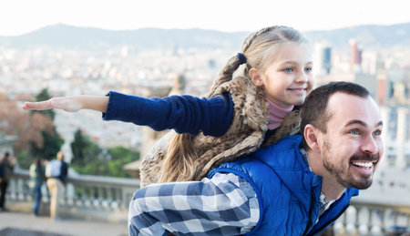 Happy father and small daughter enjoying city walkの写真素材
