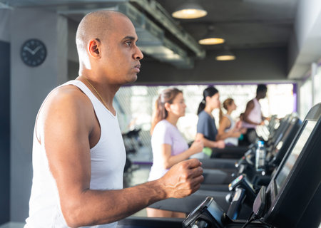 Man training on treadmill at fitness center