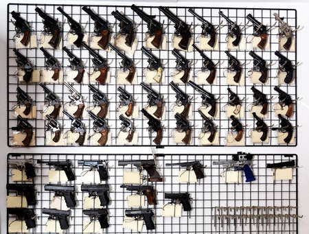 Gun shop with revolvers and pistols on showcaseの写真素材