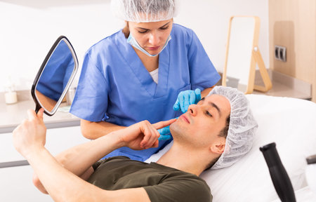Cosmetologist giving consultation to male patient