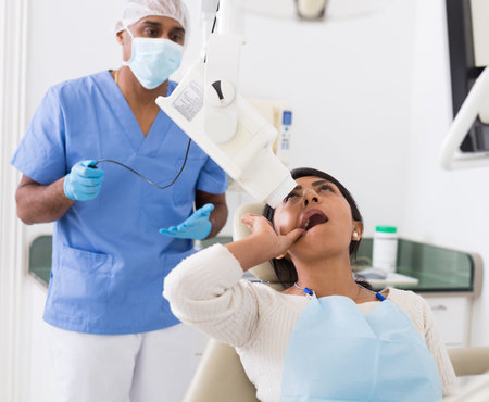 Dentist makes x-ray of patients teeth