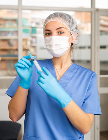 Female nurse or doctor wearing in face mask and medical uniform