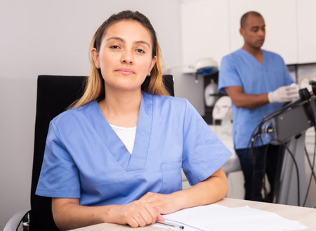 Positive female doctor cosmetologist filling medical forms