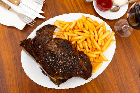Image of a grilled beef steak and fried potatoes.の写真素材