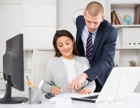 Business people man and woman discussing paperwork