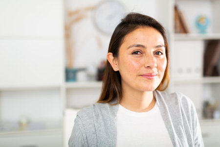 Positive businesswoman posing in office