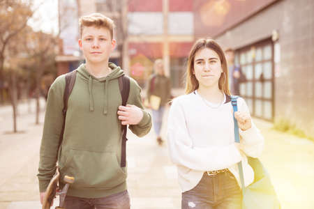 Carefree teen students boy and girl friendly talkingの写真素材