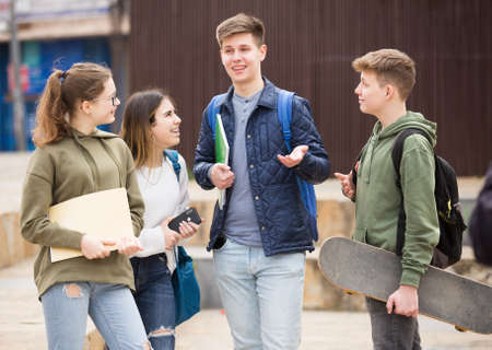 Teenagers have fun talking on streetの写真素材