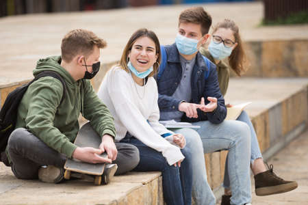 Teenage friends in face masks spending time togetherの写真素材