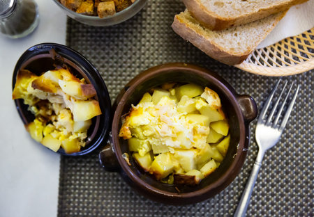 Appetizing roast with potatoes, served in clay potの写真素材