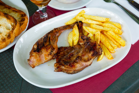 Dish of fried rabbit and French fries.の写真素材