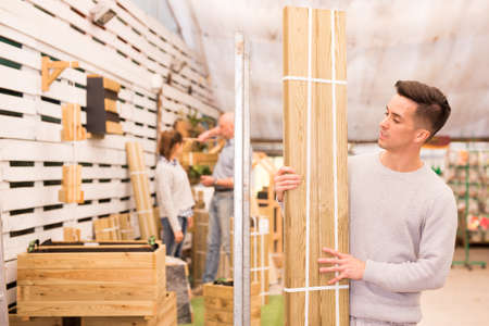 Guy buying wooden boardsの写真素材
