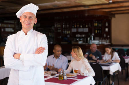 Portrait of confident professional pizzeria chef in restaurant hallの写真素材